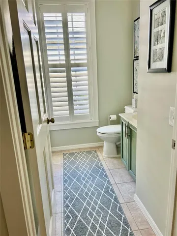 a bathroom with a toilet a sink and a mirror