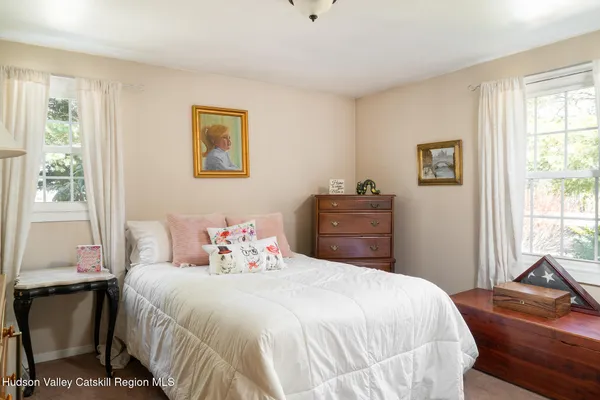 a view of a lake with a floor to ceiling window and wooden floor