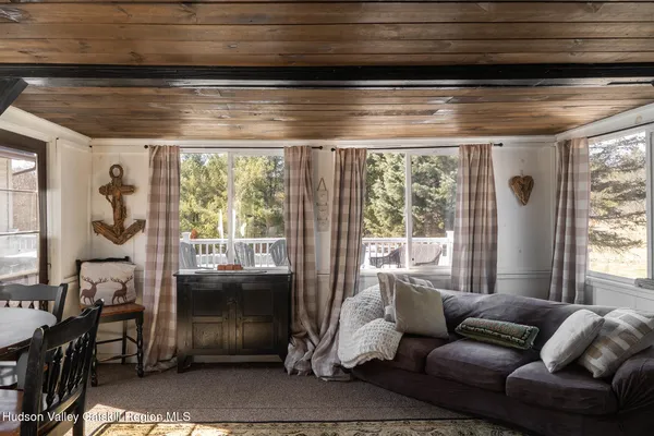 a bedroom with furniture and a flat screen tv
