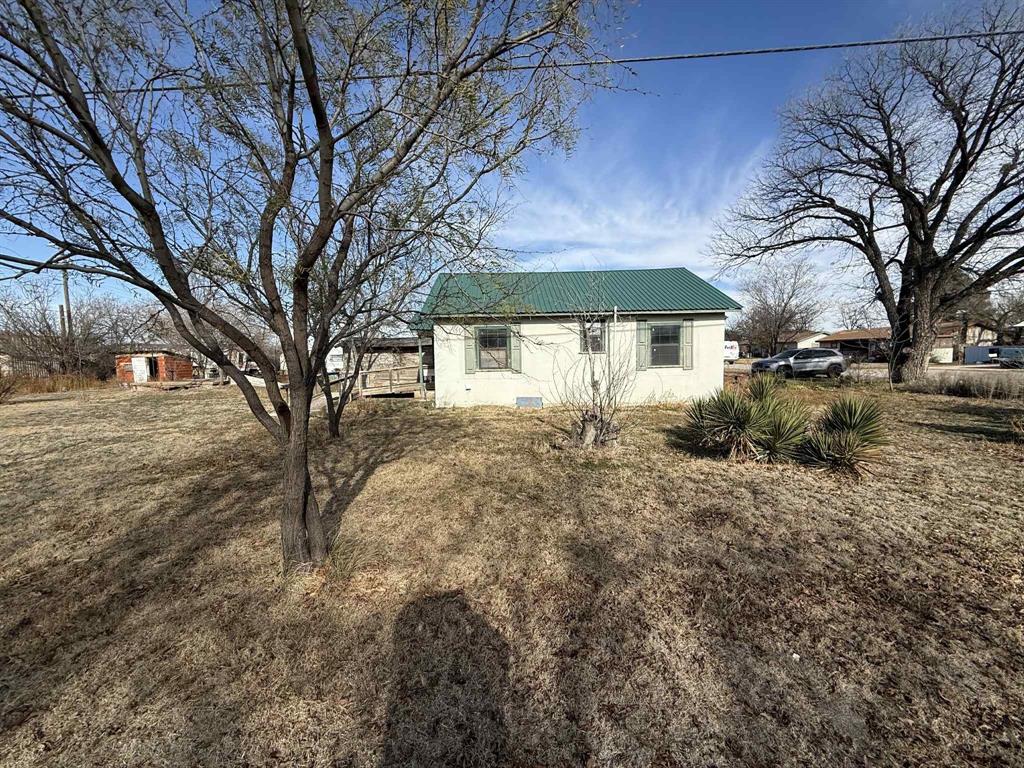 110 Hickory Street Roscoe, TX 79545 - Photo 5 of 6 a white house that has a tree in it