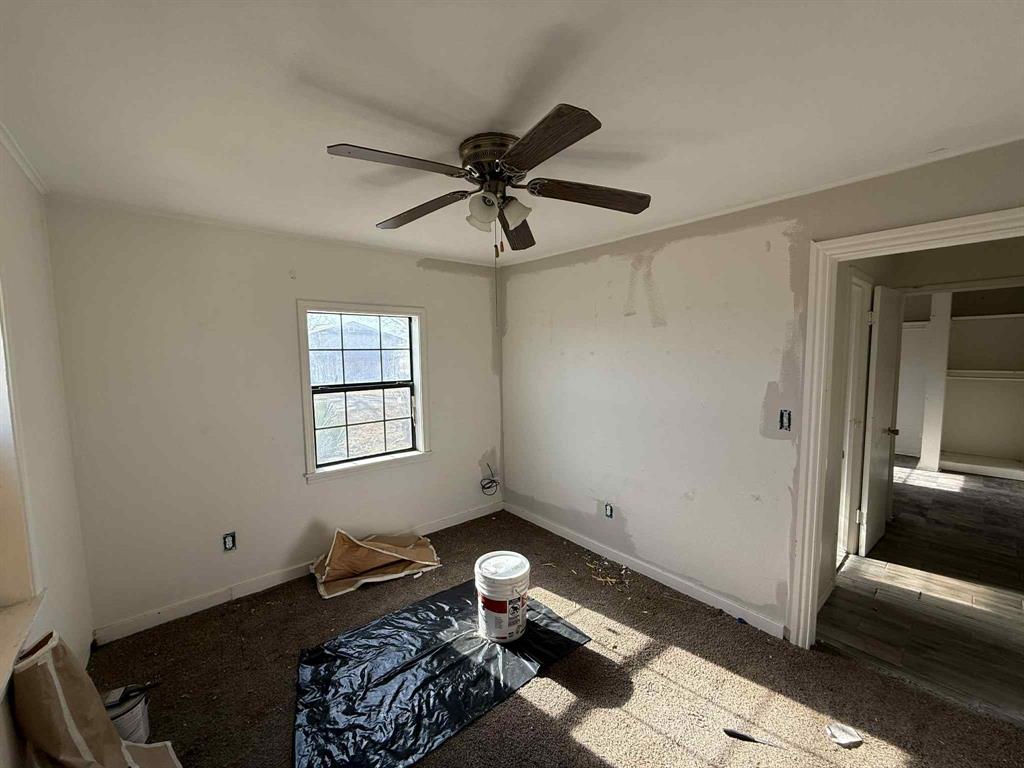 110 Hickory Street Roscoe, TX 79545 - Photo 5 of 9 a bedroom with a bed and a window