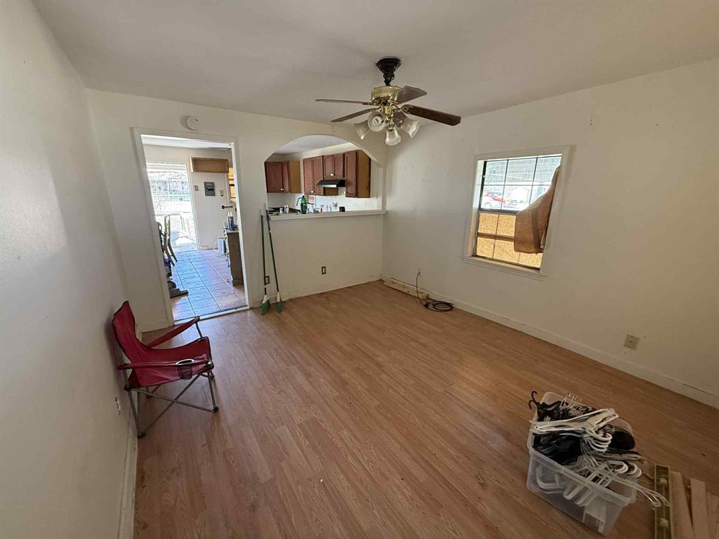 110 Hickory Street Roscoe, TX 79545 - Photo 8 of 9 a living room with furniture and a wooden floor