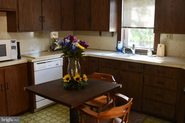 a kitchen with a sink cabinets and window