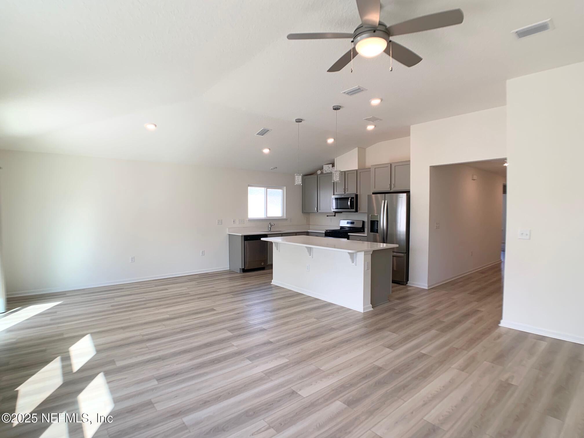 7948 Rippa Vly Way Jacksonville, FL 32222 - Photo 15 of 30 a view of kitchen with refrigerator microwave and stove