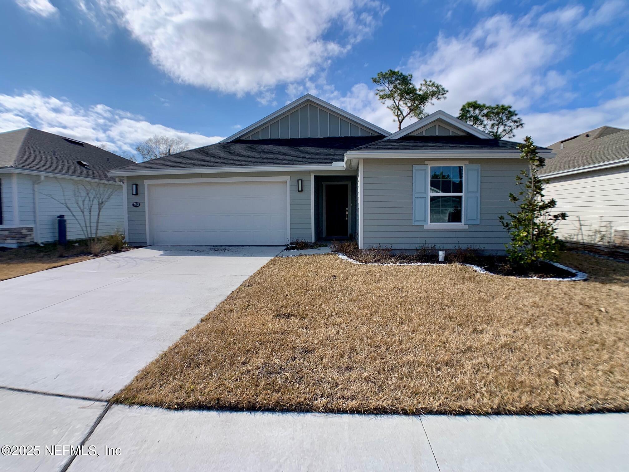 7948 Rippa Vly Way Jacksonville, FL 32222 - Photo 2 of 30 a front view of a house with a yard and garage
