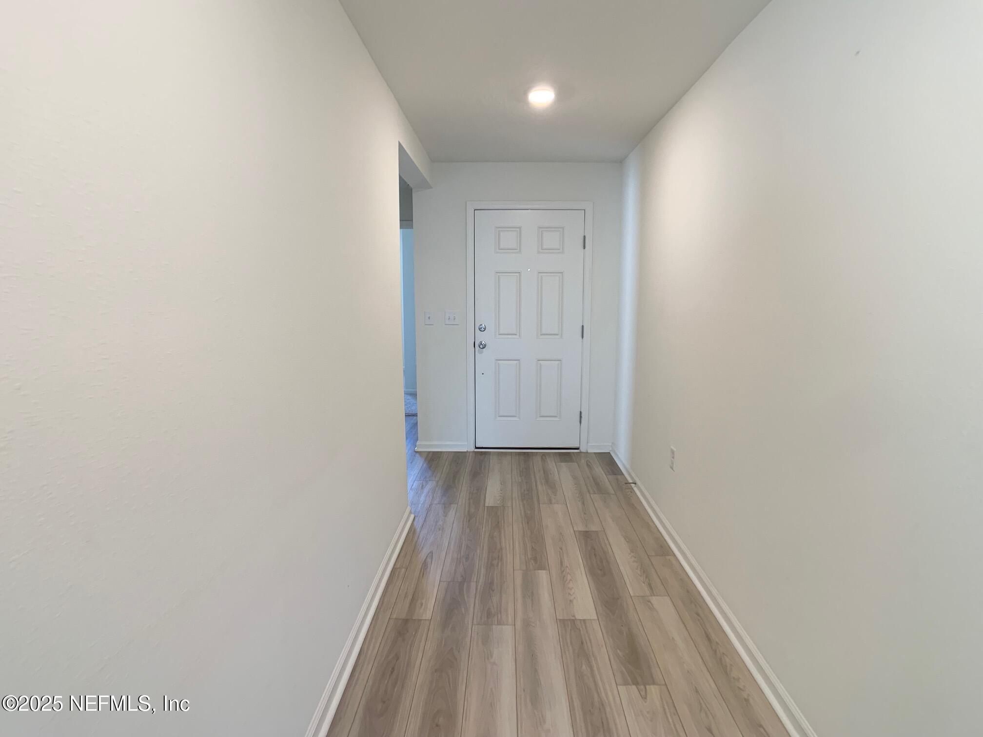 7948 Rippa Vly Way Jacksonville, FL 32222 - Photo 3 of 30 a view of a hallway with wooden floor