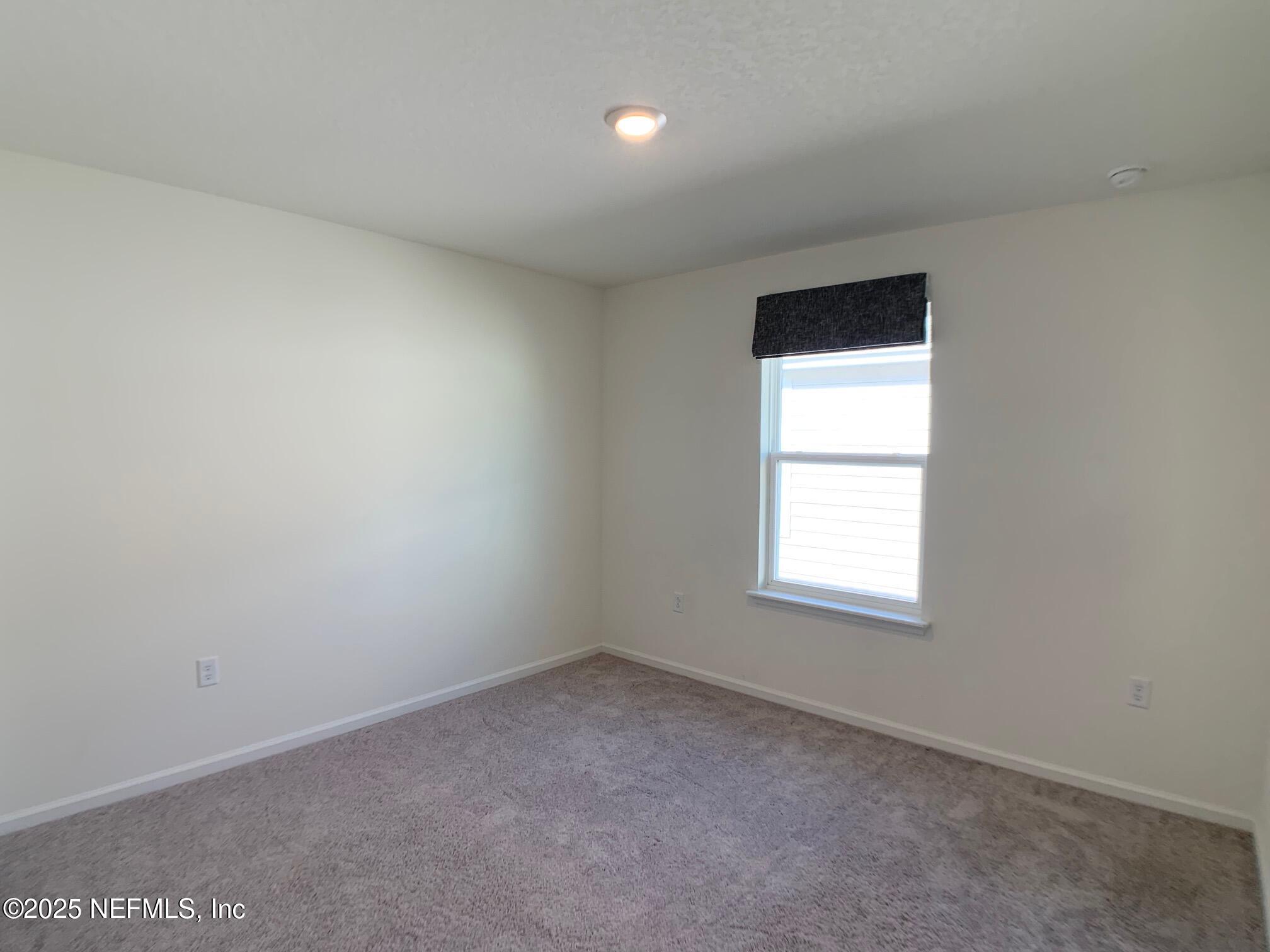7948 Rippa Vly Way Jacksonville, FL 32222 - Photo 4 of 30 an empty room with a window