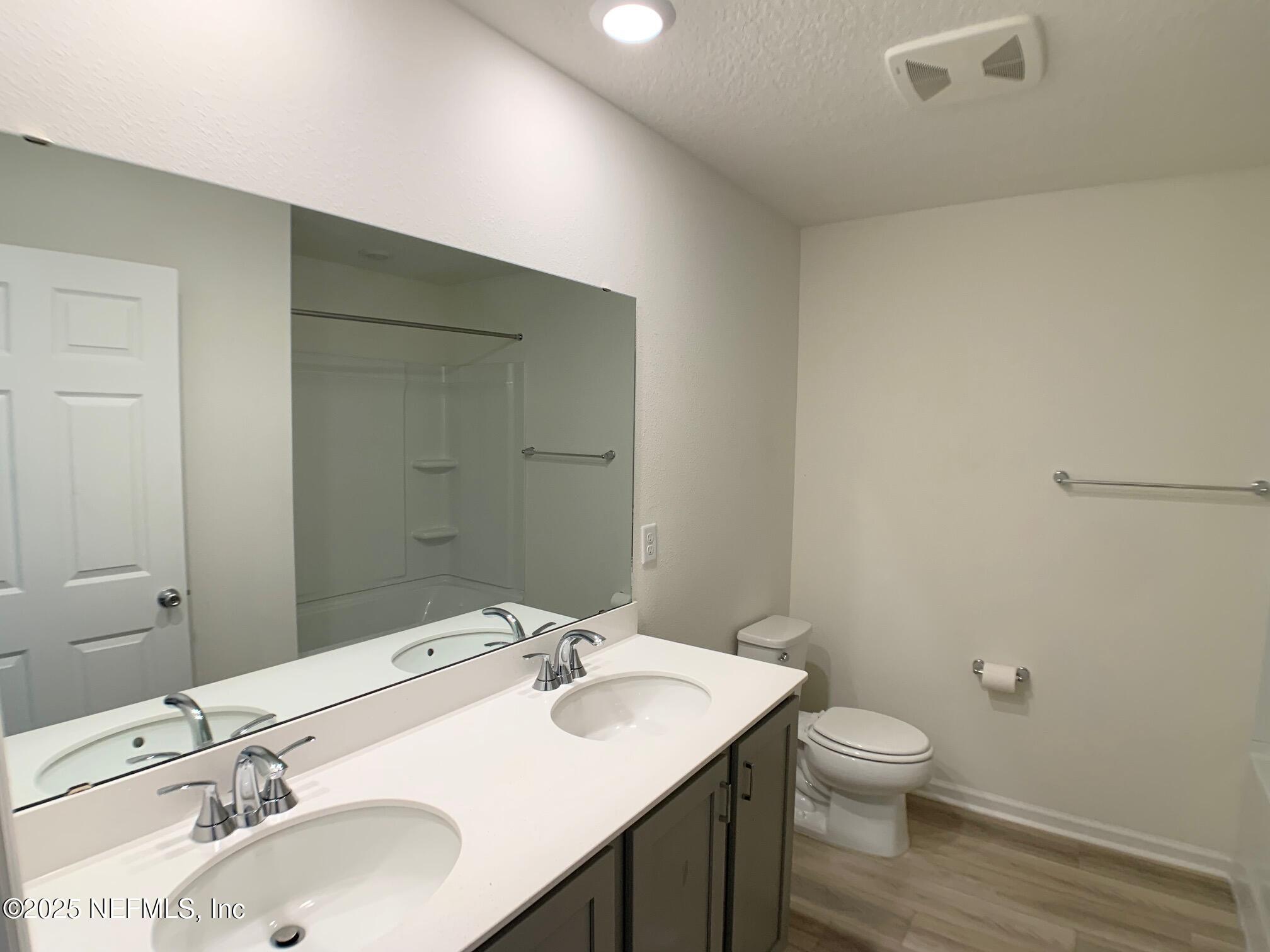 7948 Rippa Vly Way Jacksonville, FL 32222 - Photo 6 of 30 a bathroom with a sink toilet and a mirror