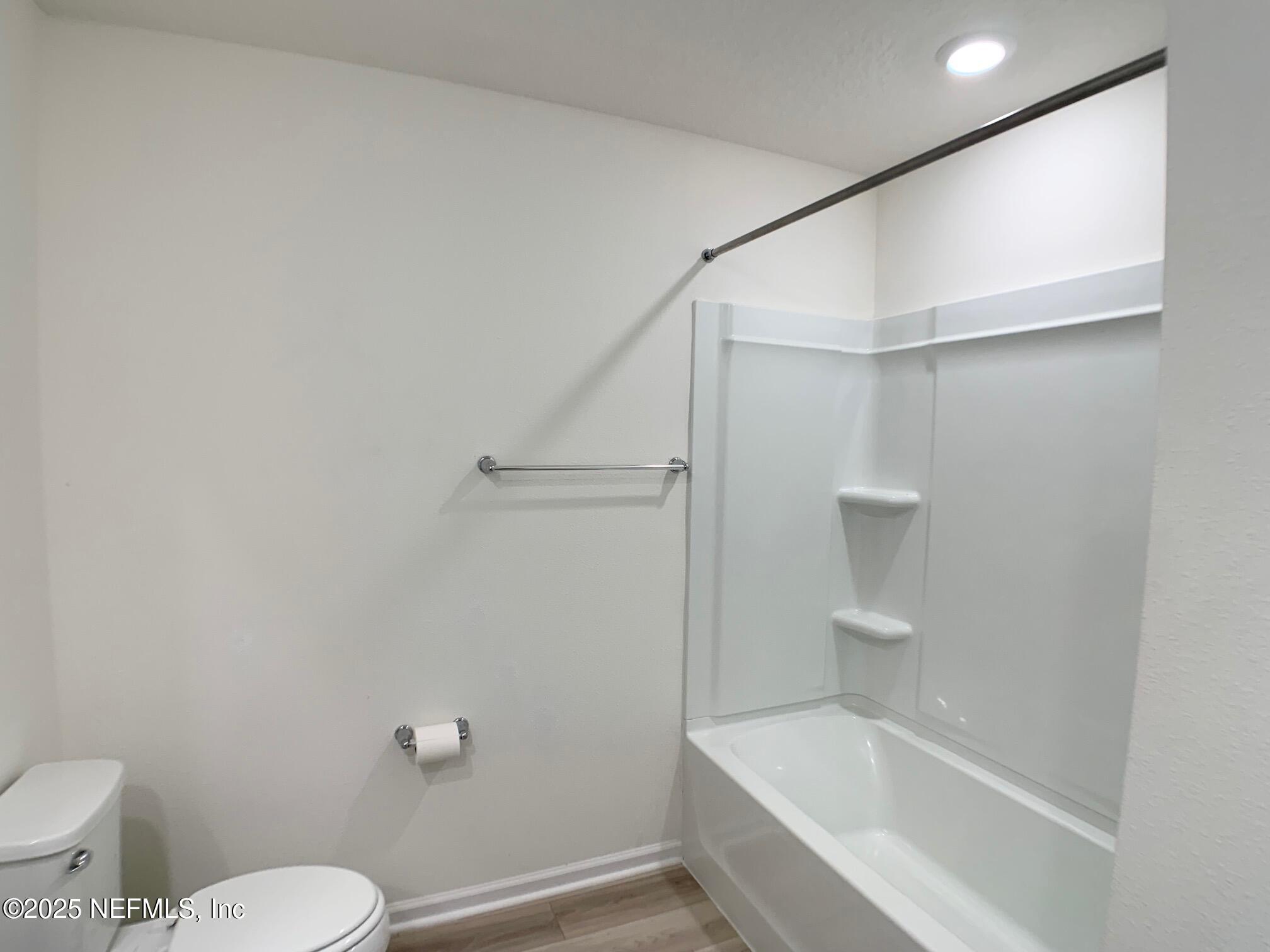 7948 Rippa Vly Way Jacksonville, FL 32222 - Photo 7 of 30 a white toilet sitting next to a bath tub