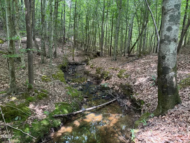 a view of a yard with table and chair and wooden fence