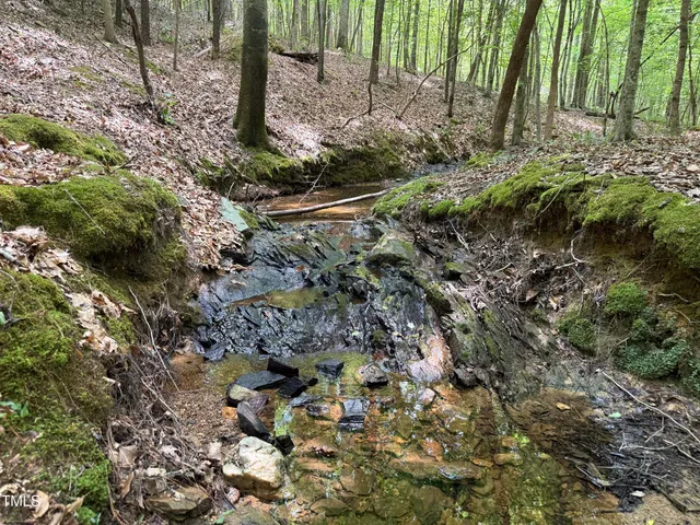 a sign broad in front of a red brick house