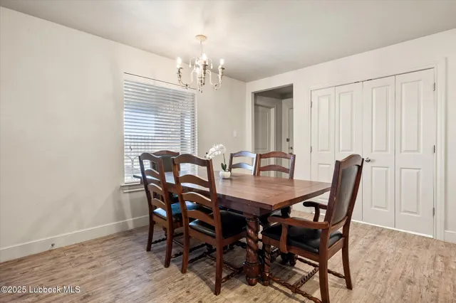 a view of a dining room with furniture and chandelier