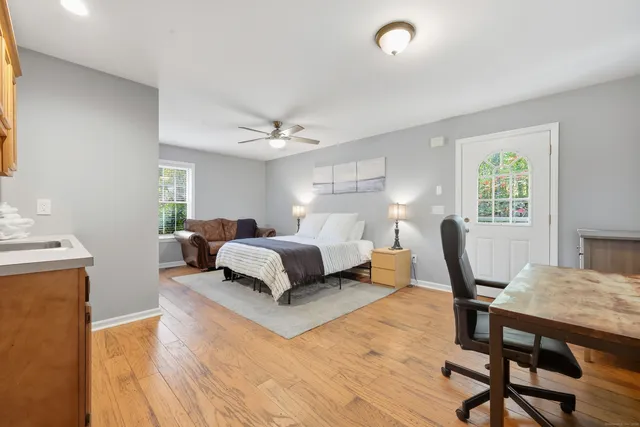 a bedroom with a bed and wooden floor