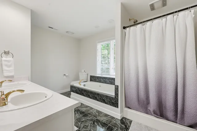 a en suite bathroom with a sink and a mirror