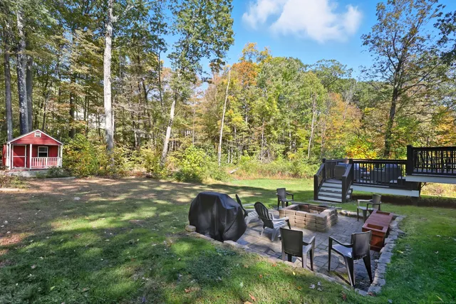 a view of a patio with chairs and plants
