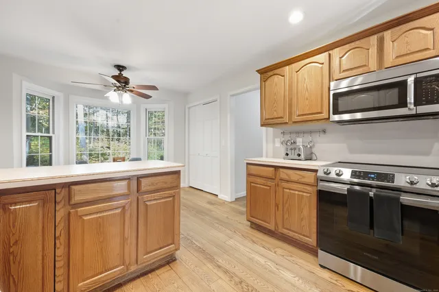 a kitchen with stainless steel appliances granite countertop a stove microwave and sink