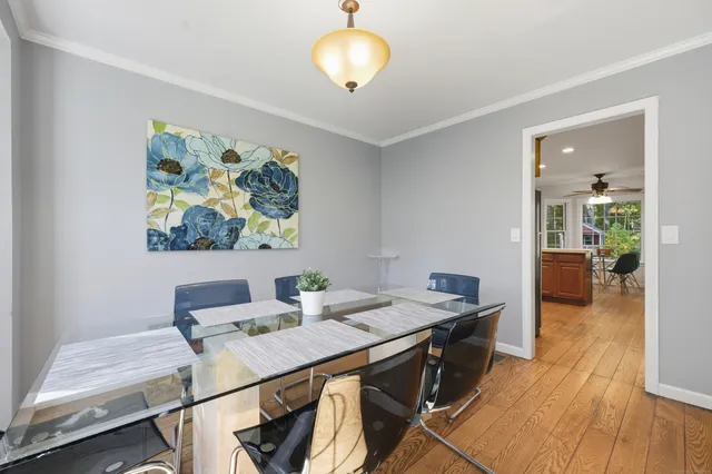 a view of a dining room with furniture and wooden floor