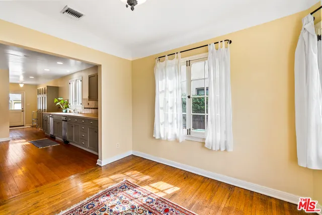 a large kitchen with stainless steel appliances a large counter top a stove a sink and a refrigerator