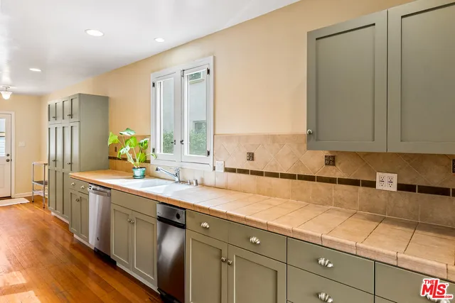 a kitchen with stainless steel appliances granite countertop a stove and a sink