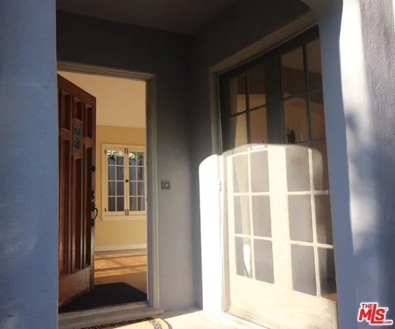 a view of empty room with wooden floor and fireplace