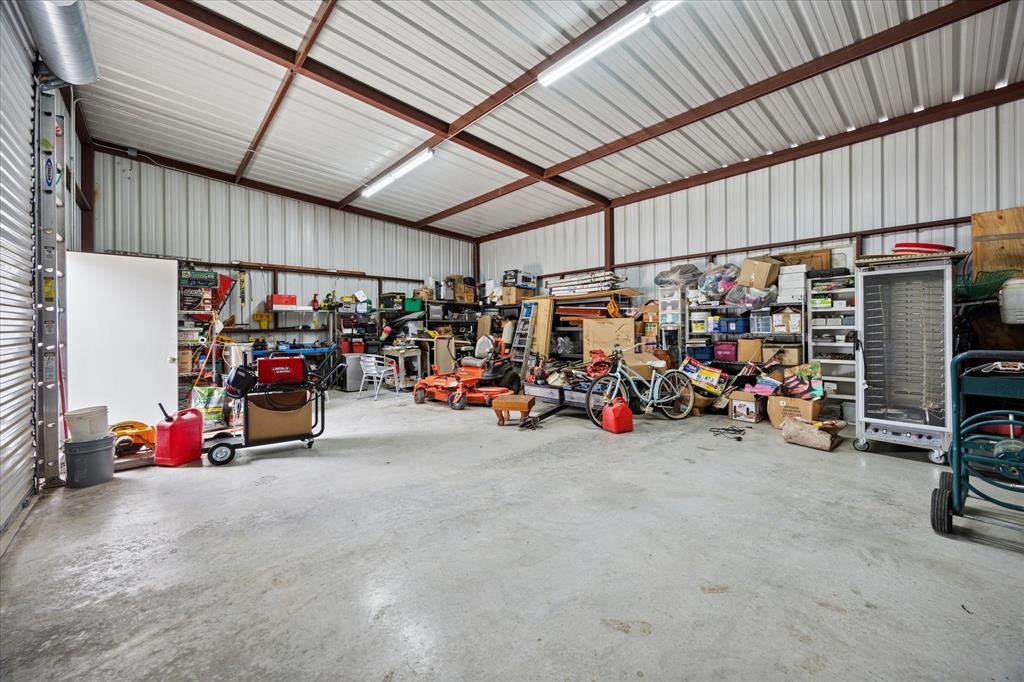 119 George Owens Road Ponder, TX 76259 - Photo 21 of 26 Spacious metal-frame building featuring a corrugated metal roof, durable concrete flooring, and ample storage capacity