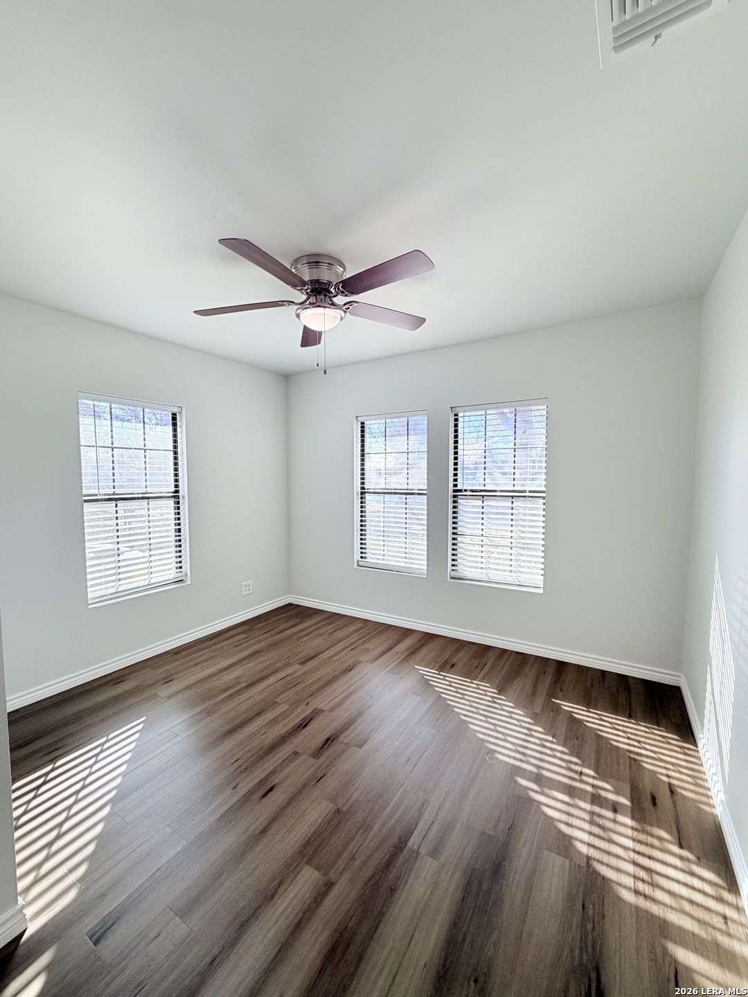 255 Cumberland Road San Antonio, TX 78204 - Photo 11 of 18 a view of an empty room with wooden floor and a window