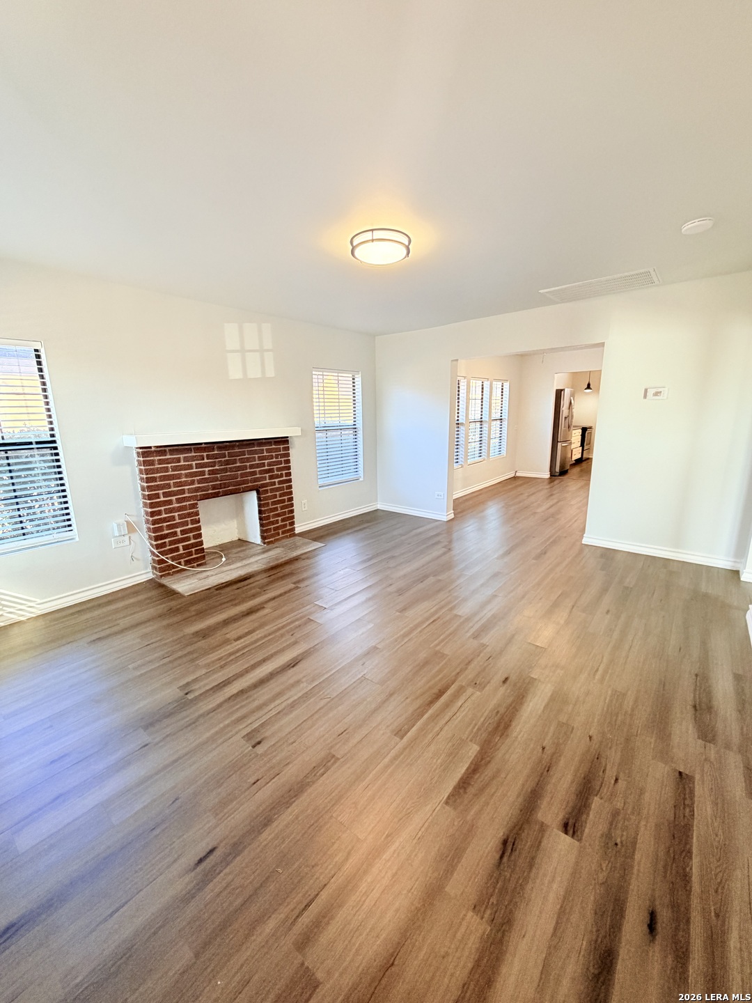 255 Cumberland Road San Antonio, TX 78204 - Photo 3 of 18 a view of a livingroom with wooden floor and a fireplace
