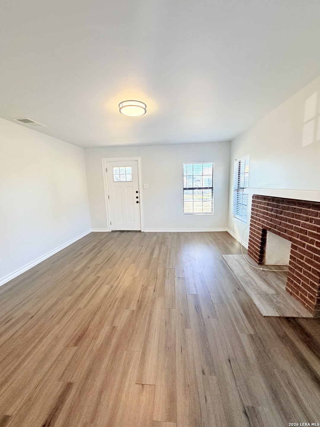 255 Cumberland Road San Antonio, TX 78204 - Photo 4 of 18 a view of an empty room with wooden floor and window