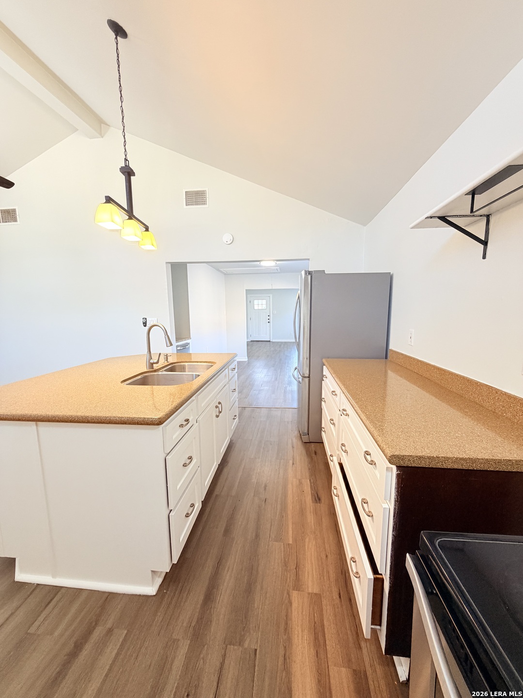 255 Cumberland Road San Antonio, TX 78204 - Photo 8 of 18 a large white kitchen with sink and wooden floor
