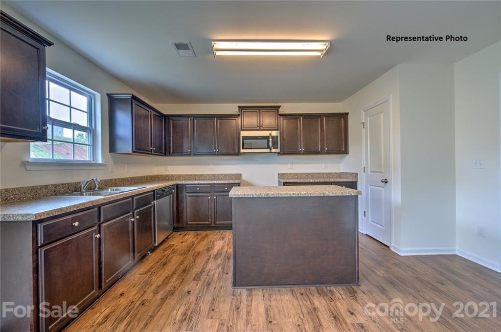 7112 Finnigan Road Charlotte, NC 28215 - Photo 13 of 33 a kitchen with stainless steel appliances granite countertop wooden cabinets a stove top oven a sink and dishwasher