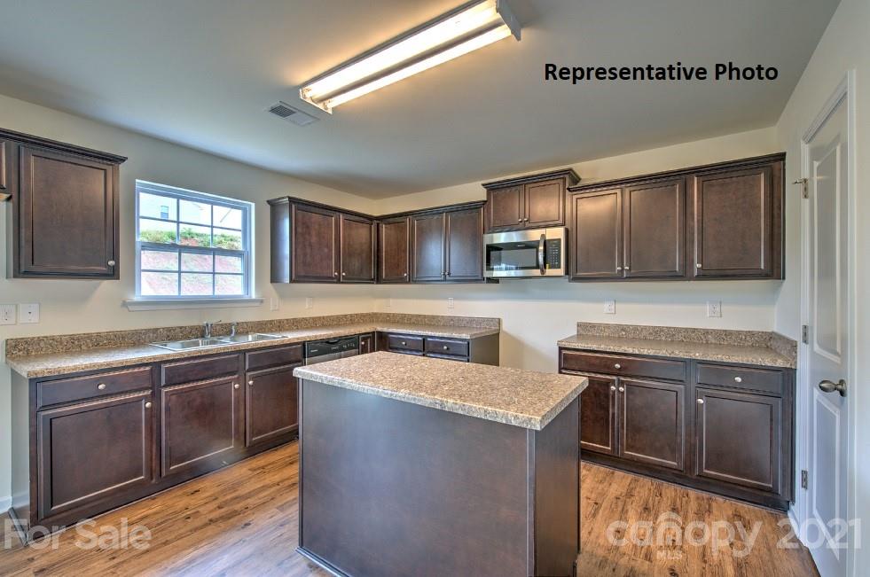 7112 Finnigan Road Charlotte, NC 28215 - Photo 16 of 33 a kitchen with stainless steel appliances granite countertop a sink stove and cabinets