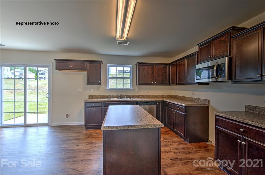 7112 Finnigan Road Charlotte, NC 28215 - Photo 19 of 33 a kitchen with stainless steel appliances granite countertop a stove a sink and a microwave
