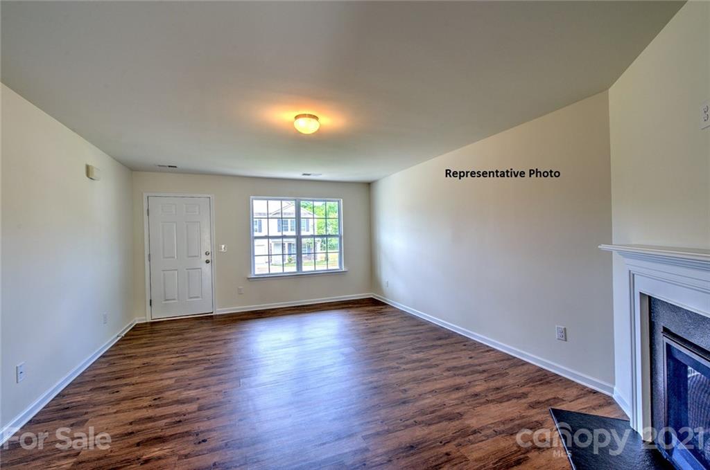 7112 Finnigan Road Charlotte, NC 28215 - Photo 3 of 33 an empty room with wooden floor and windows