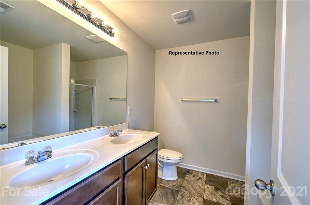 7112 Finnigan Road Charlotte, NC 28215 - Photo 27 of 33 a bathroom with a sink and a mirror