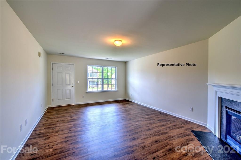 7112 Finnigan Road Charlotte, NC 28215 - Photo 4 of 33 an empty room with wooden floor and windows