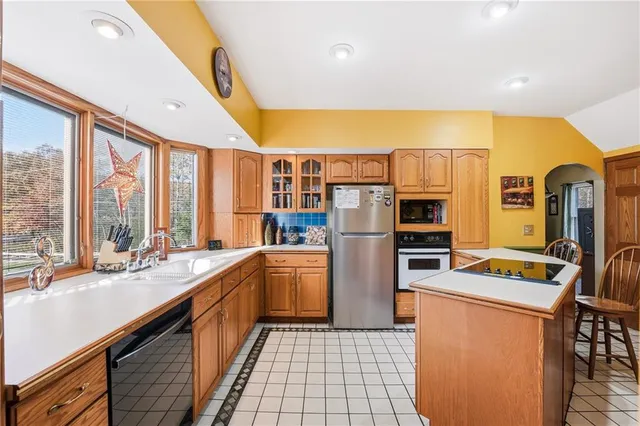 a kitchen with refrigerator and cabinets