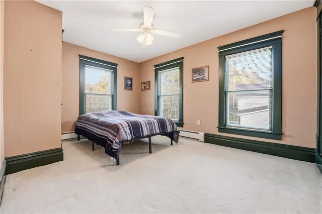a bedroom with a bed lamp and a window