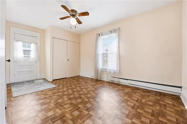 a view of a livingroom with a ceiling fan and window
