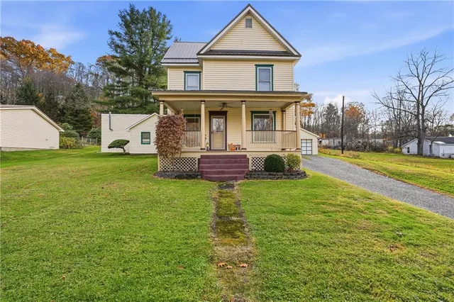 a front view of a house with a garden