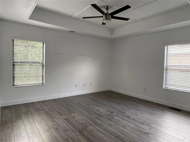 wooden floor in an empty room with a window