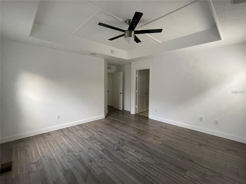 3739 Seneca Club Loop, Unit A Orlando, FL 32808 - Photo 12 of 31 wooden floor in an empty room