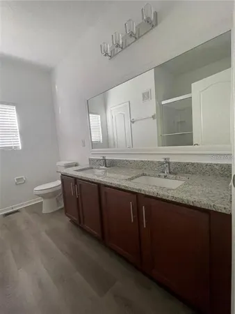 a bathroom with a granite countertop bathtub and double sink