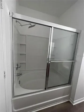 a bathroom with a glass shower door