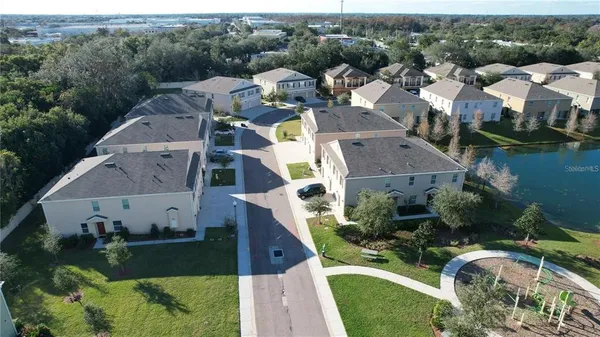 an aerial view of multiple houses with yard