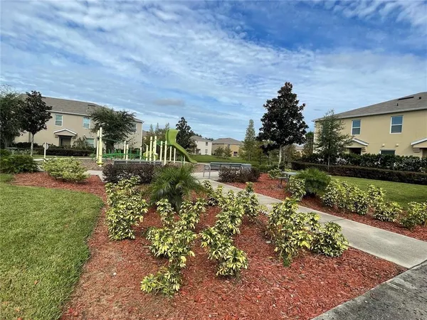 a view of outdoor space with playground and green space