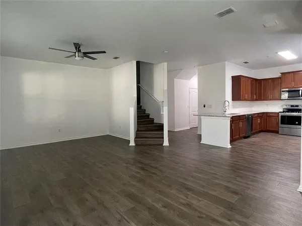 a view of kitchen with wooden floor and electronic appliances