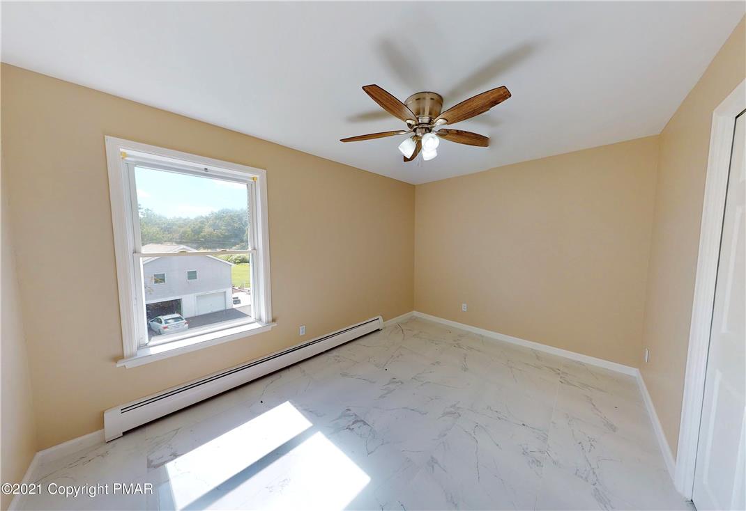 1110 Misty Ridge East Stroudsburg, PA 18302 - Photo 32 of 43 A well-lit room featuring durable tile flooring and a ceiling fan for comfort.