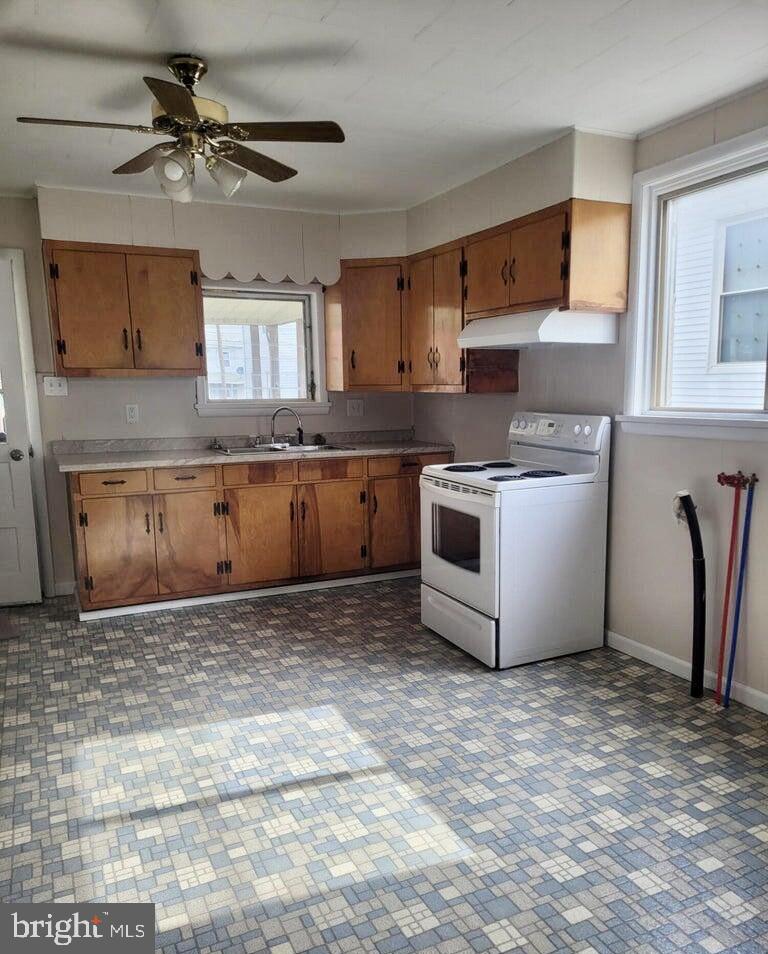 230 Walnut Street Sunbury, PA 17801 - Photo 27 of 33 a kitchen with stainless steel appliances granite countertop a stove a sink and a refrigerator