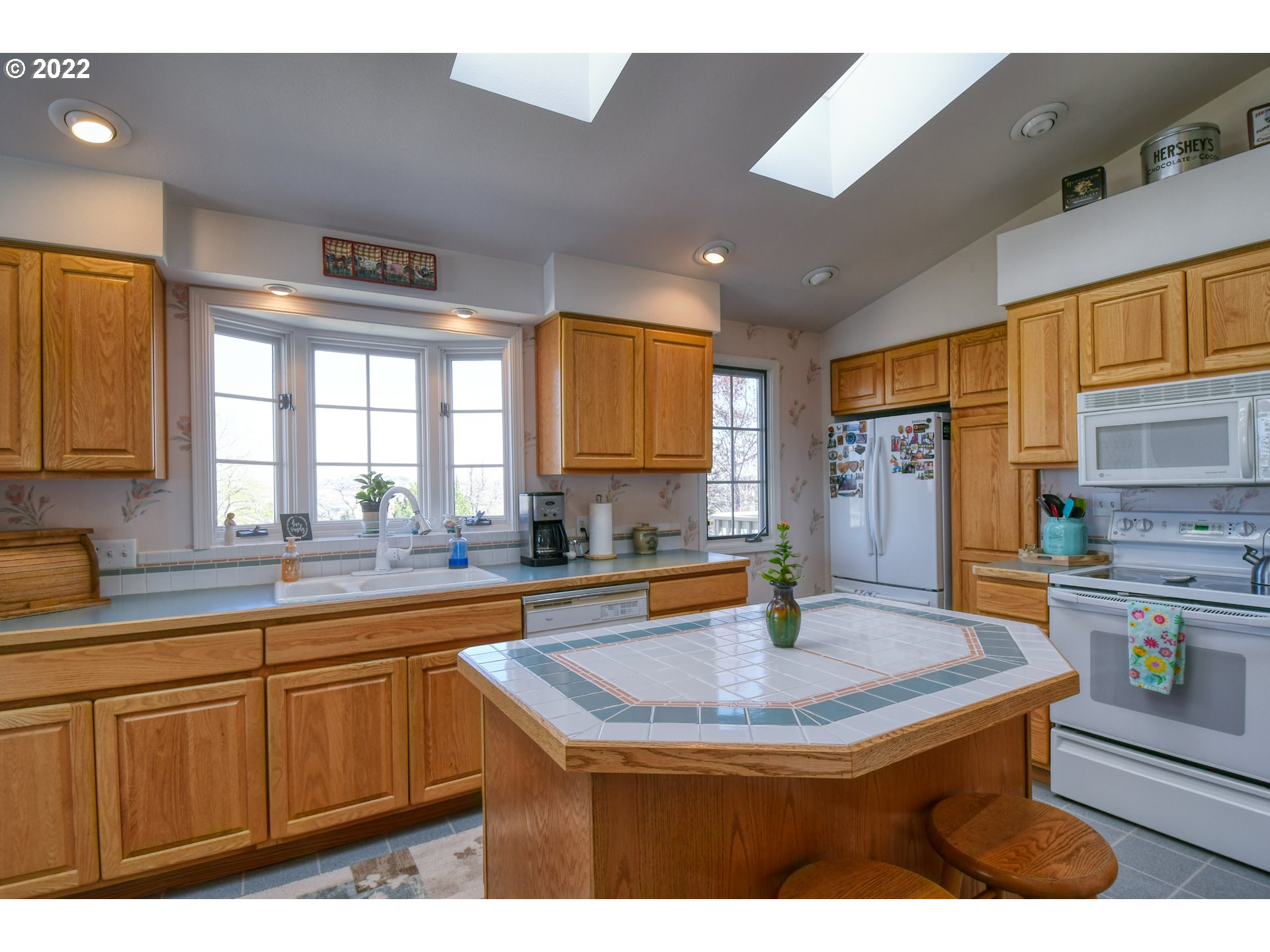 2209 Southwest Ladow Avenue Pendleton, OR 97801 - Photo 9 of 24 a kitchen with stainless steel appliances granite countertop a sink dishwasher and cabinets with wooden floor