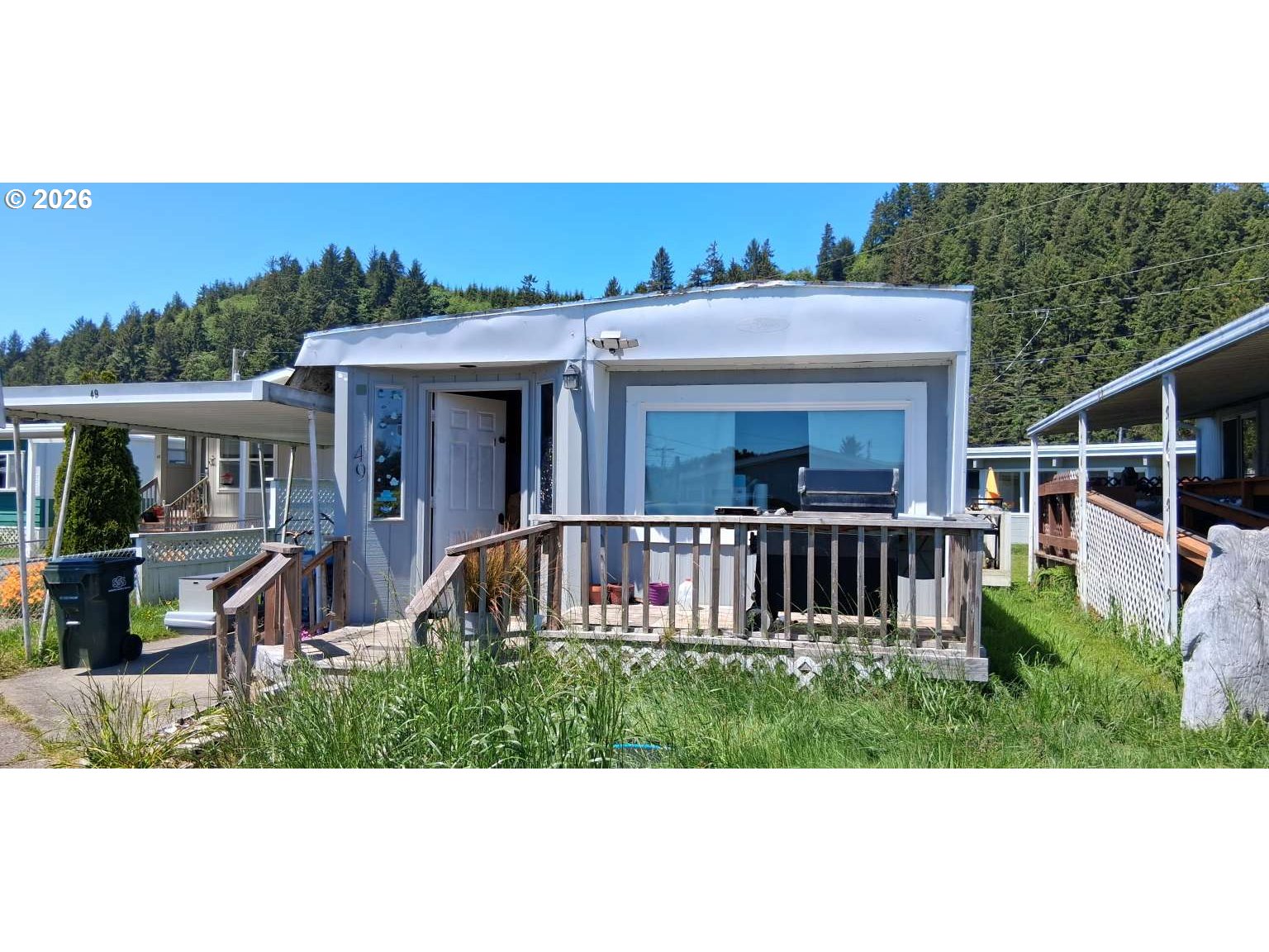 1413 Hawthorne Avenue, Unit 49 Reedsport, OR 97467 - Photo 6 of 10 a view of a house with a deck and furniture